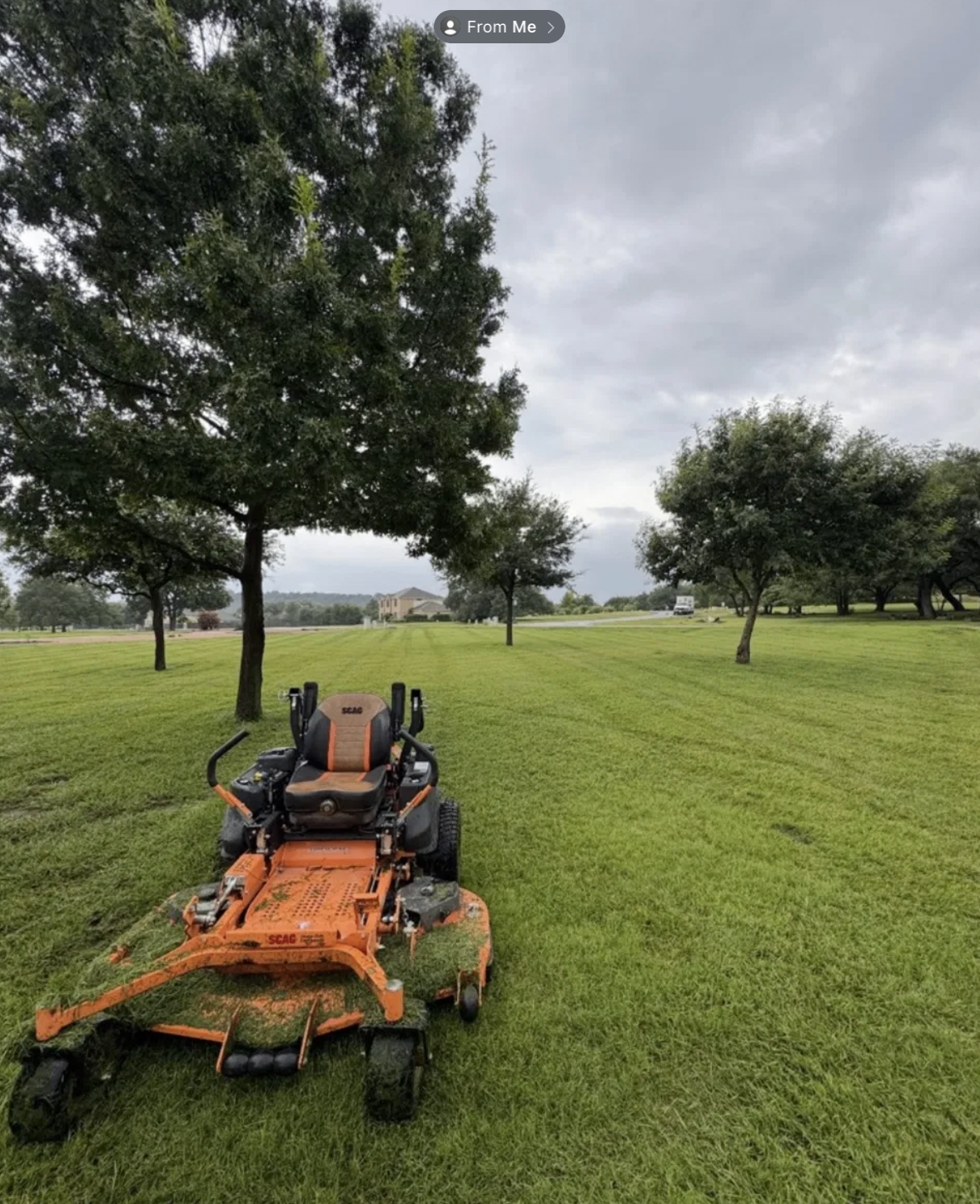 Orange zero-turn mower on a freshly cut lawn in Austin, TX